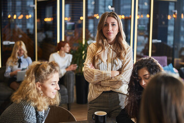 Beautiful young woman working with colleagues in office