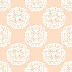 Seamless pattern of mandala flowers on a light orange background