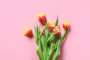 A bouquet of tulips as a gift for March 8, Mother's Day, Valentine's Day. Easter decor. Top view. Flowers tulips on a pink background.