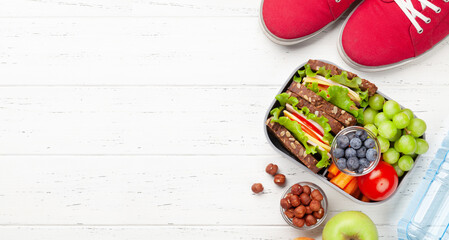 Healthy school lunch box with sandwich and fresh vegetables