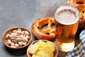 Lager beer, nuts, potato chips and fresh homemade pretzel