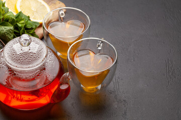 Herbal tea with mint and lemon. Tea cup and teapot