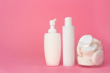 Stack of cotton discs and skicare cosmetic bottle