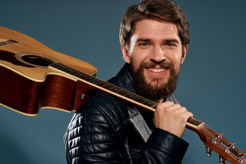 Male musician in leather jacket performed by musical group guitar