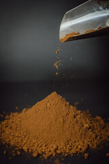 Coffee powder is poured out of the scoop