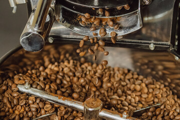 Pouring coffee beans. Coffee beans in the grinder. Cooling down coffee beans.