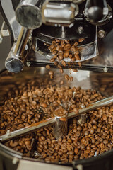 Pouring coffee beans. Coffee beans in the grinder. Cooling down coffee beans.