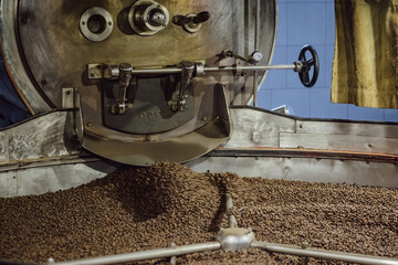 Coffee being mixed in a coffee roasting machine. Mixing coffee.