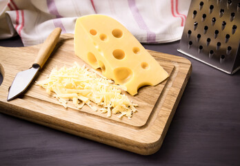 Fresh cheese on a wooden board. On black background.