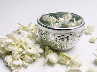 Water in bowl mixed with Jasmine flowers, Songkran festival in Thailand.