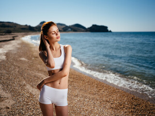 Fototapeta na wymiar Pretty woman in white swimsuit island Horizon summer vacation ocean