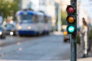 view of city traffic with traffic lights, in the foreground a semaphore with a green light
