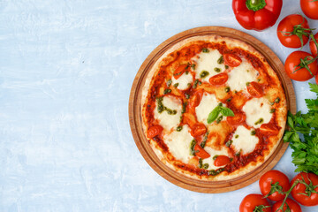 Top view of pizza Margherita on gray surface