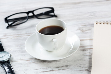 Top view office desk with white cup of coffee