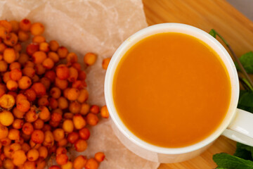 Sea buckthorn tea served on wooden table