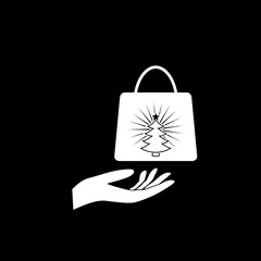 Hand offering Christmas Shopping bag icon isolated on dark background