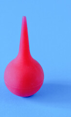 Obraz premium Medical enema, pear for procedures on a blue background.