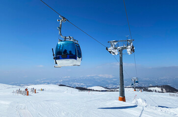 Fototapeta na wymiar Gondola lift at ski resort in winter