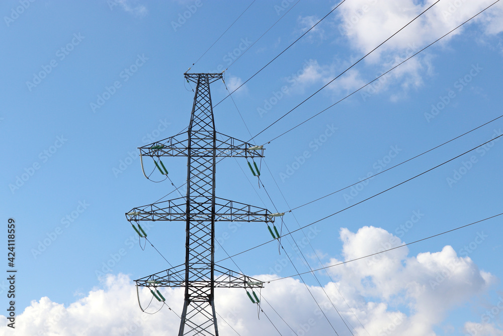 Wall mural high voltage tower with electrical wires on blue sky with white clouds. electricity transmission lin