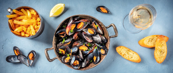 Mussels panorama with wine, fries, and toasts