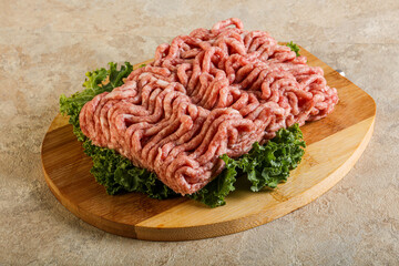 Raw pork minced meat over board