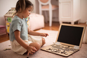 Toddler playing interactive games for good development at home.