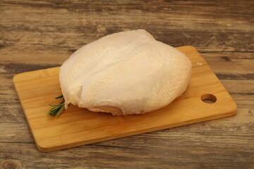 Raw whole chicken breast with skin