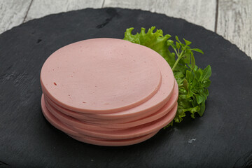 Sliced pork natural sausages over board