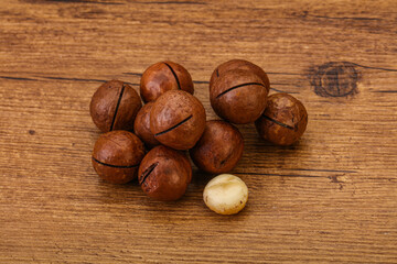Brown macadamia nut heap over background