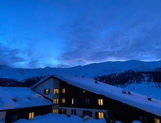 Winter weekend, night view of the mountains. Ski resort. House in the mountains. Livigno, Italy