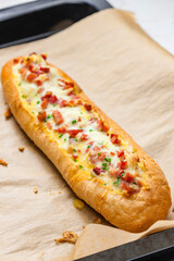 baked baguette filled with cheese and ham