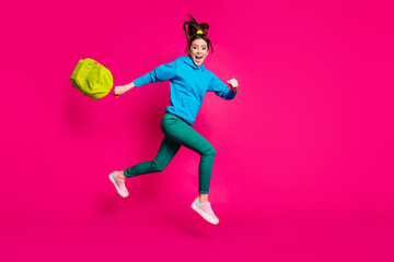 Fototapeta na wymiar Full length photo of attractive young lady wear blue sweater holding schoolbag jumping running isolated pink color background