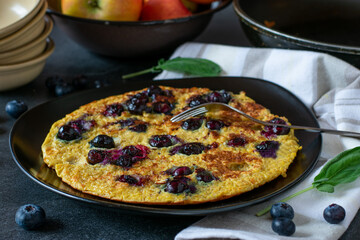 Healthy breakfast pancake with oatmeal and blueberries on a plate