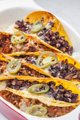 tacos filled with minced meat and black beans
