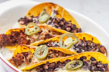 tacos filled with minced meat and black beans