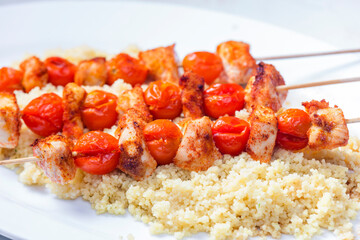 chcicken meat and tomato skewers with couscous