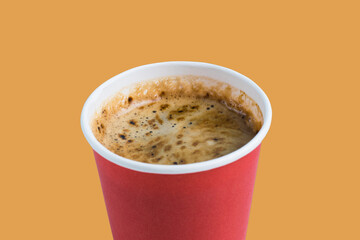 Coffee to go in a paper red glass without a lid on a terracotta background, top view, close-up