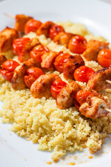 chcicken meat and tomato skewers with couscous