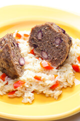 meat balls filled with red beans on rice with red pepper