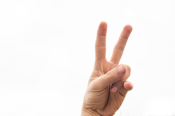 A hand doing number two gesture on blue background. Gesturing number 2. Peace or victory symbol. Number two letter V in sign language. Being second concept. Hand counting two. Space for ad text.