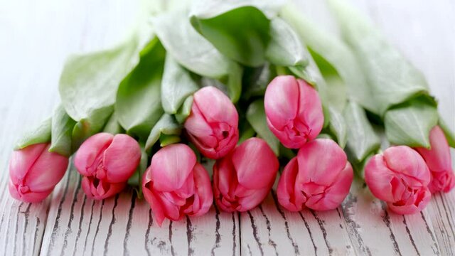 Bouquet of pink tulips on a white wooden background. concept of womens day, Mothers day, 8 March, 4K