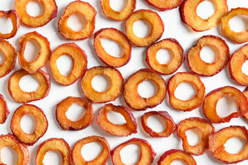 Pattern of plums chips on white background. Fall harvest. Home drying. Snack food.