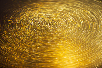 gold and yellow light particles in a circular rotation