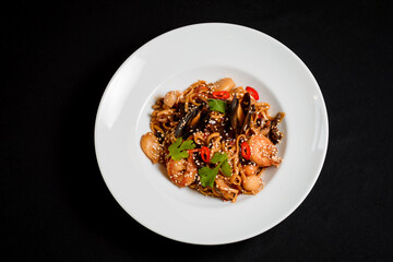 Decorated seafood pasta in a white plate