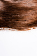 Dark long hair rests on a white background