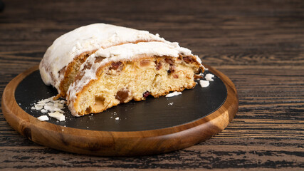 Golden authentic German Stollen on cutting board. Perfect Stollen pie on wooden table. Close up