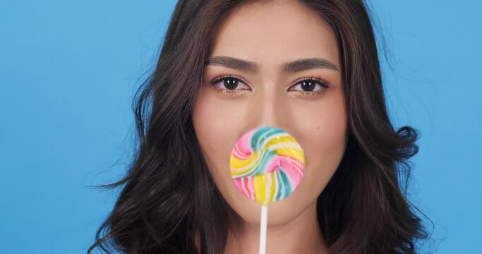 Young women delicious expression with suck candy sweet.