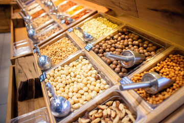 Many different nuts are sold on the counter in the store.