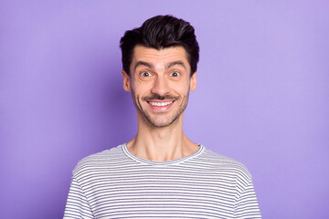Photo of handsome young man beaming smile wear black-and-white striped t-shirt isolated purple background