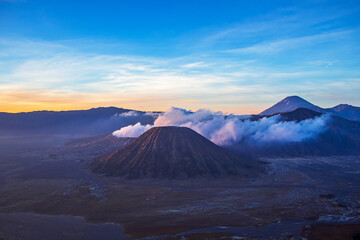 Terrific Bromo Tengger Semeru National Park on East Java, Indonesia. Aerial view of erupting volcano Bromo, Mount Semeru and Mount Batok from Penanjakan view point, observation area to see sunrise.